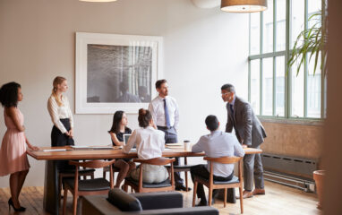 Young professionals around a table at a business meeting