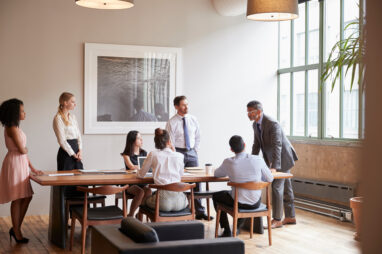 Young professionals around a table at a business meeting