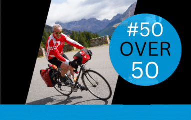 Rob Mcivor descends the Col de Vars wearing red cycling gear. The image also carries the #50Over50 logo